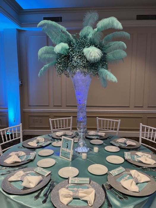 leah and co sweet sixteen tor centerpiece feathers flowersquoise